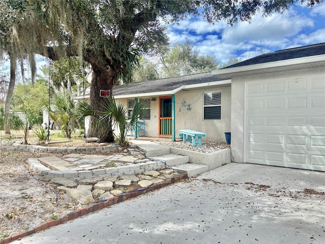 3767 Pinstar Ter, North Port, FL 34287 - view of front of home with stucco siding, an attached garage, driveway, and roof with shingles