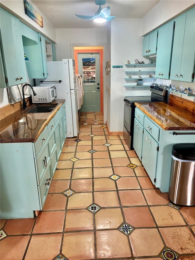 3767 Pinstar Ter, North Port, FL 34287 - kitchen featuring electric stove, blue cabinets, dark countertops, open shelves, and light tile patterned floors