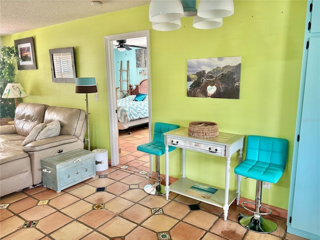 3767 Pinstar Ter, North Port, FL 34287 - living area with ceiling fan, light tile patterned floors, and a textured ceiling