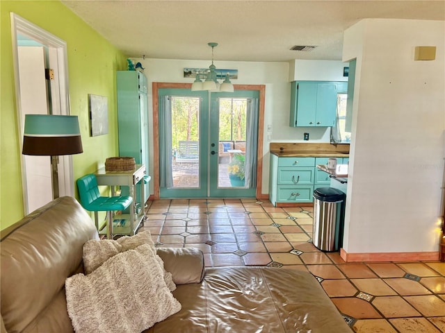 3767 Pinstar Ter, North Port, FL 34287 - doorway featuring light tile patterned floors, a chandelier, french doors, and a textured ceiling