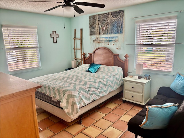 3767 Pinstar Ter, North Port, FL 34287 - bedroom featuring light tile patterned floors, a textured ceiling, and ceiling fan