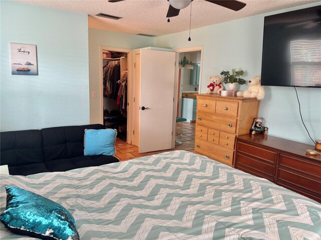 3767 Pinstar Ter, North Port, FL 34287 - bedroom with a closet, a textured ceiling, a spacious closet, and ceiling fan