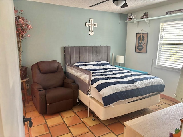 3767 Pinstar Ter, North Port, FL 34287 - bedroom featuring a textured ceiling, light tile patterned flooring, and a ceiling fan