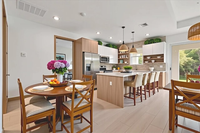 102 Arrow Ln, Rotonda West, FL 33947 - kitchen with stainless steel appliances, open shelves, healthy amount of natural light, tasteful backsplash, and recessed lighting