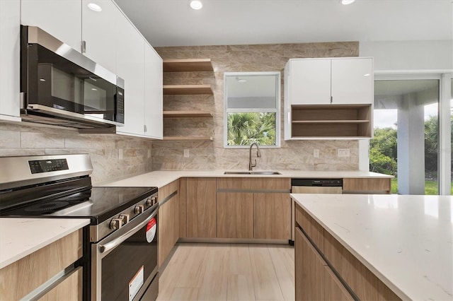 102 Arrow Ln, Rotonda West, FL 33947 - kitchen with appliances with stainless steel finishes, open shelves, tasteful backsplash, and recessed lighting