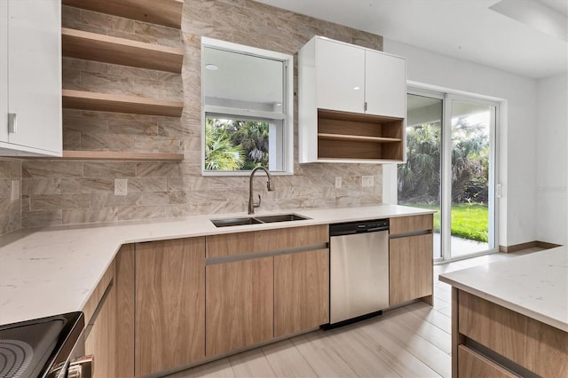 102 Arrow Ln, Rotonda West, FL 33947 - kitchen with dishwasher, open shelves, tasteful backsplash, stove, and white cabinets