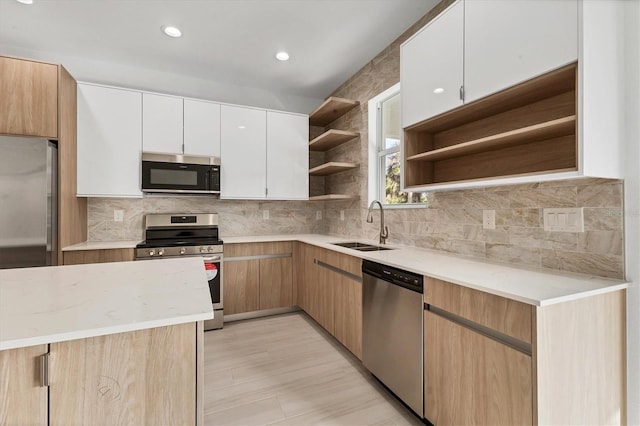 102 Arrow Ln, Rotonda West, FL 33947 - kitchen featuring appliances with stainless steel finishes, open shelves, tasteful backsplash, white cabinetry, and recessed lighting