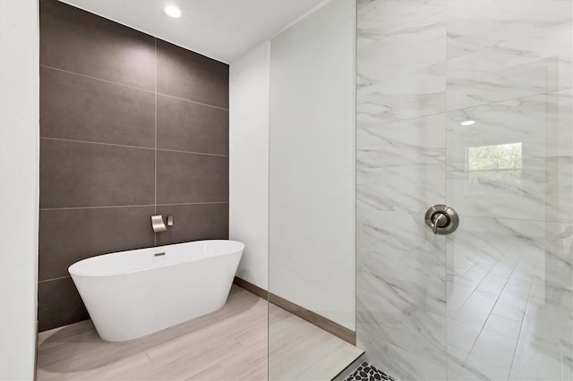 102 Arrow Ln, Rotonda West, FL 33947 - bathroom with a tile shower, a soaking tub, and tile walls