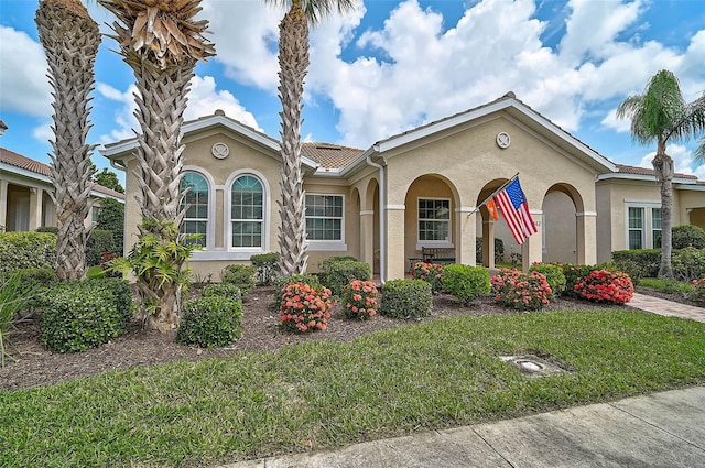 5662 Fossano Dr, Sarasota, FL 34238 - mediterranean / spanish house with stucco siding and a front yard