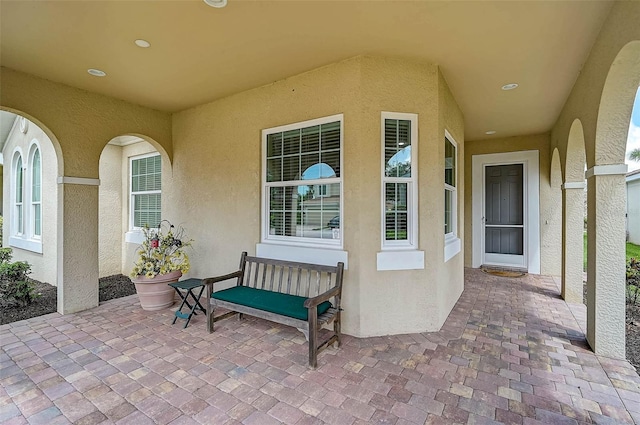 5662 Fossano Dr, Sarasota, FL 34238 - view of exterior entry with stucco siding and a patio