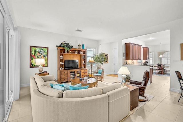 5662 Fossano Dr, Sarasota, FL 34238 - living room featuring light tile patterned floors and plenty of natural light