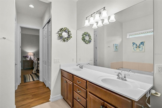 5662 Fossano Dr, Sarasota, FL 34238 - bathroom featuring ensuite bath, double vanity, and wood finished floors