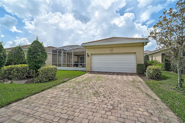 5662 Fossano Dr, Sarasota, FL 34238 - view of front facade featuring decorative driveway, stucco siding, a garage, a lanai, and a tiled roof
