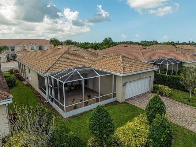 5662 Fossano Dr, Sarasota, FL 34238 - back of house featuring a tiled roof, stucco siding, an attached garage, a lanai, and decorative driveway