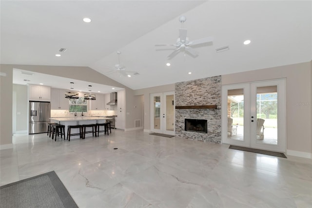 920 Lena Ln, Sarasota, FL 34240 - living area featuring french doors, vaulted ceiling, plenty of natural light, a ceiling fan, and recessed lighting