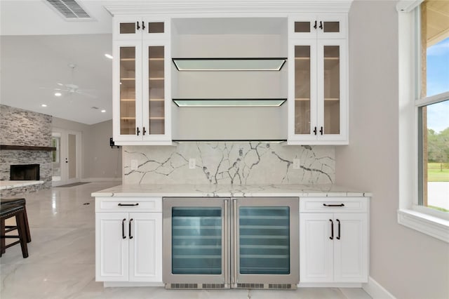 920 Lena Ln, Sarasota, FL 34240 - indoor dry bar with beverage cooler, decorative backsplash, a large fireplace, recessed lighting, and a ceiling fan
