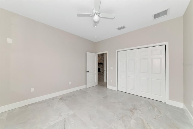 920 Lena Ln, Sarasota, FL 34240 - unfurnished bedroom with light marble finish floors, a ceiling fan, and a closet