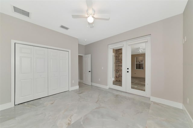 920 Lena Ln, Sarasota, FL 34240 - unfurnished bedroom with light marble finish flooring, a ceiling fan, french doors, and a closet