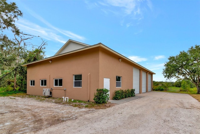 920 Lena Ln, Sarasota, FL 34240 - view of property exterior with stucco siding and a garage
