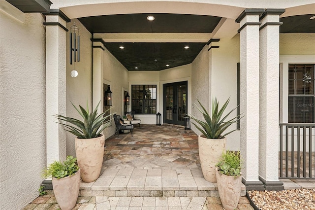 3906 Twin Rivers Trl, Parrish, FL 34219 - property entrance featuring french doors, stucco siding, and a patio