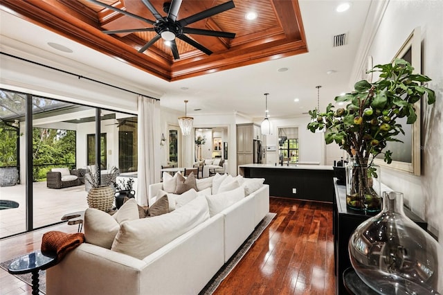 3906 Twin Rivers Trl, Parrish, FL 34219 - living room with ceiling fan, a tray ceiling, crown molding, dark wood-style floors, and recessed lighting