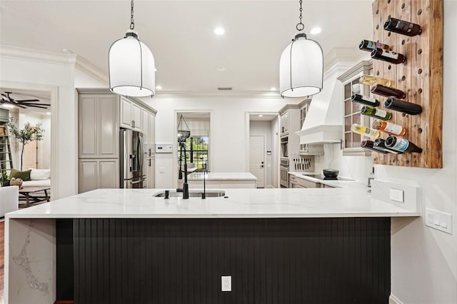 3906 Twin Rivers Trl, Parrish, FL 34219 - kitchen with appliances with stainless steel finishes, open shelves, ornamental molding, custom range hood, and a center island