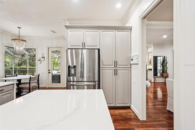 3906 Twin Rivers Trl, Parrish, FL 34219 - kitchen featuring stainless steel fridge with ice dispenser, ornamental molding, dark wood-type flooring, a chandelier, and decorative light fixtures