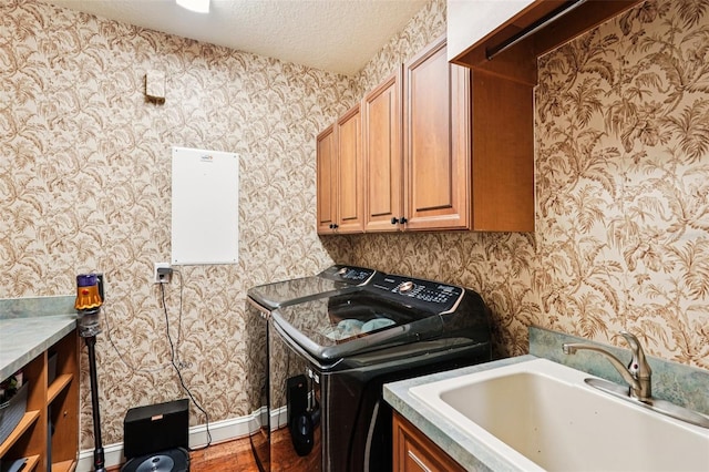 3906 Twin Rivers Trl, Parrish, FL 34219 - laundry area with cabinet space, wallpapered walls, independent washer and dryer, a textured ceiling, and wood finished floors