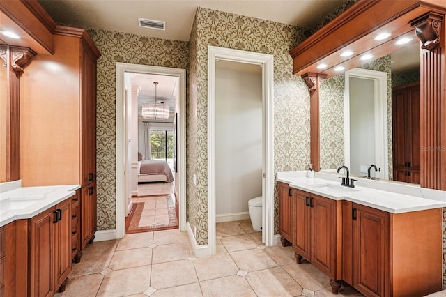 3906 Twin Rivers Trl, Parrish, FL 34219 - full bathroom with wallpapered walls, two vanities, tile patterned floors, and connected bathroom