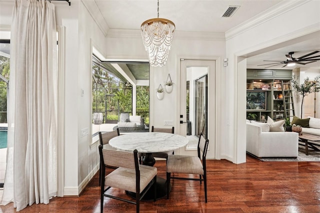3906 Twin Rivers Trl, Parrish, FL 34219 - dining space with dark wood finished floors, a chandelier, crown molding, and ceiling fan