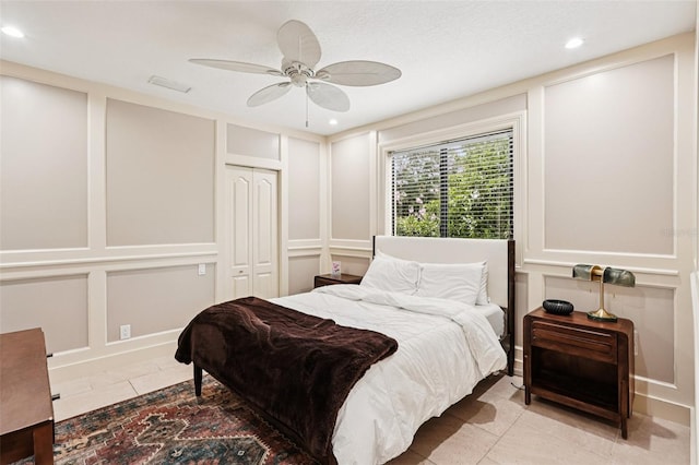 3906 Twin Rivers Trl, Parrish, FL 34219 - tiled bedroom with recessed lighting, a decorative wall, a ceiling fan, and a closet