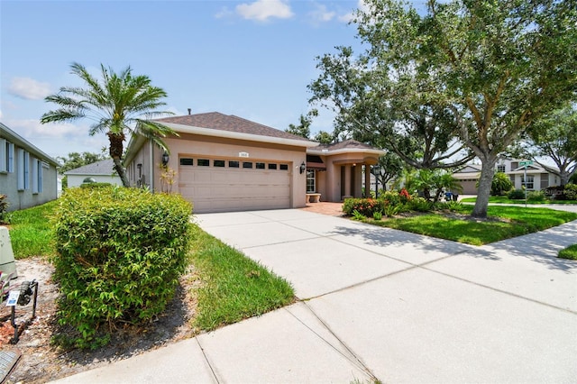 1415 Millbrook Cir, Bradenton, FL 34212 - view of front of property with a garage, concrete driveway, and stucco siding
