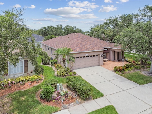 1415 Millbrook Cir, Bradenton, FL 34212 - mediterranean / spanish-style home featuring a garage, concrete driveway, stucco siding, and roof with shingles