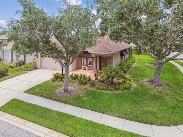 1415 Millbrook Cir, Bradenton, FL 34212 - view of property hidden behind natural elements with stucco siding, concrete driveway, a front yard, a garage, and covered porch