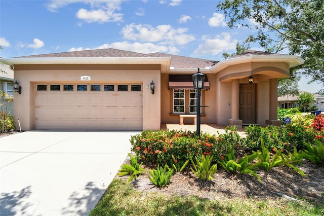 1415 Millbrook Cir, Bradenton, FL 34212 - view of front of home with an attached garage, concrete driveway, and stucco siding