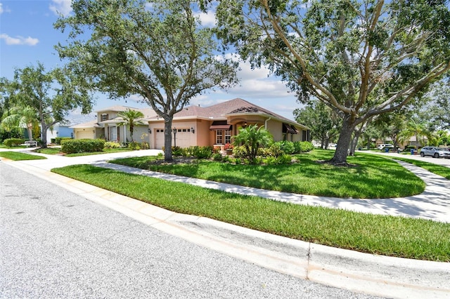 1415 Millbrook Cir, Bradenton, FL 34212 - view of front of house with an attached garage, stucco siding, concrete driveway, and a front lawn