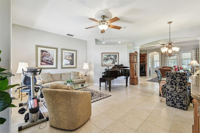 1415 Millbrook Cir, Bradenton, FL 34212 - living area featuring arched walkways, a ceiling fan, ornate columns, light tile patterned floors, and a chandelier