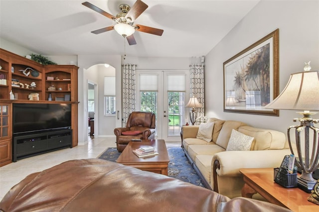 1415 Millbrook Cir, Bradenton, FL 34212 - living room with arched walkways, light tile patterned floors, french doors, and a ceiling fan