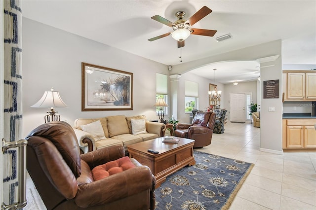1415 Millbrook Cir, Bradenton, FL 34212 - living room featuring ornate columns, ceiling fan, light tile patterned floors, and arched walkways
