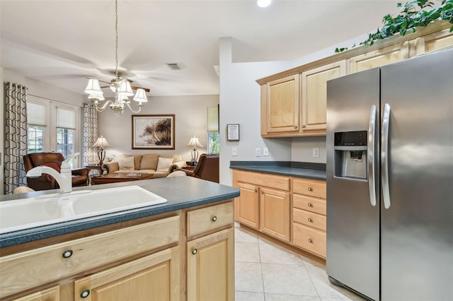 1415 Millbrook Cir, Bradenton, FL 34212 - kitchen with stainless steel fridge with ice dispenser, light brown cabinetry, and a chandelier