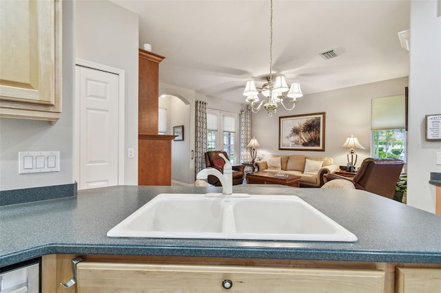 1415 Millbrook Cir, Bradenton, FL 34212 - kitchen with arched walkways, dark countertops, a chandelier, and open floor plan