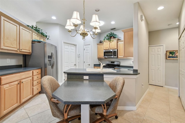 1415 Millbrook Cir, Bradenton, FL 34212 - kitchen featuring stainless steel appliances, dark countertops, light brown cabinetry, a chandelier, and light tile patterned floors