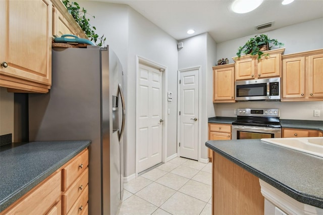 1415 Millbrook Cir, Bradenton, FL 34212 - kitchen featuring stainless steel appliances, light tile patterned flooring, dark countertops, light brown cabinetry, and recessed lighting