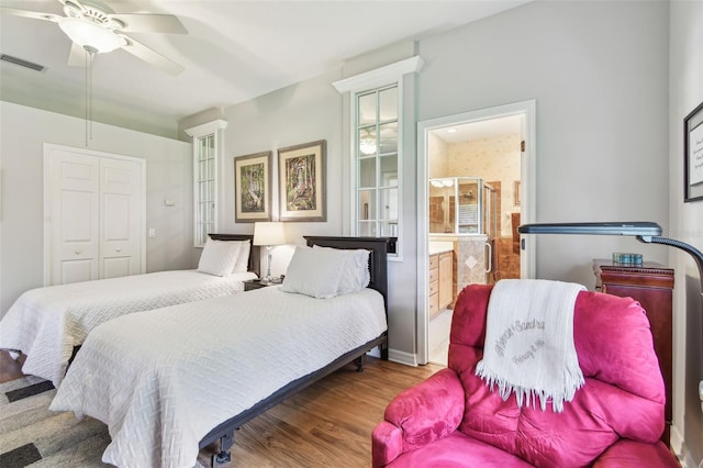 1415 Millbrook Cir, Bradenton, FL 34212 - bedroom featuring wood finished floors, ensuite bathroom, ceiling fan, and a closet
