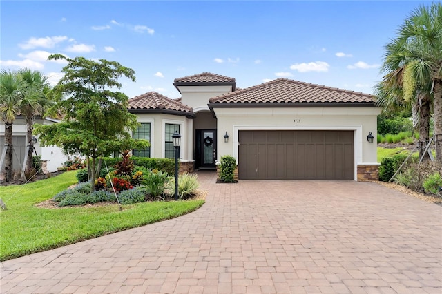 4735 Cassio Ct, Bradenton, FL 34211 - mediterranean / spanish-style home with decorative driveway, a garage, stucco siding, a tile roof, and a front yard