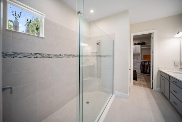 4735 Cassio Ct, Bradenton, FL 34211 - bathroom featuring a shower stall, vanity, a walk in closet, and tile patterned floors