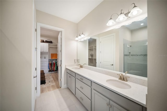 4735 Cassio Ct, Bradenton, FL 34211 - bathroom featuring a walk in closet, double vanity, a shower stall, and tile patterned floors