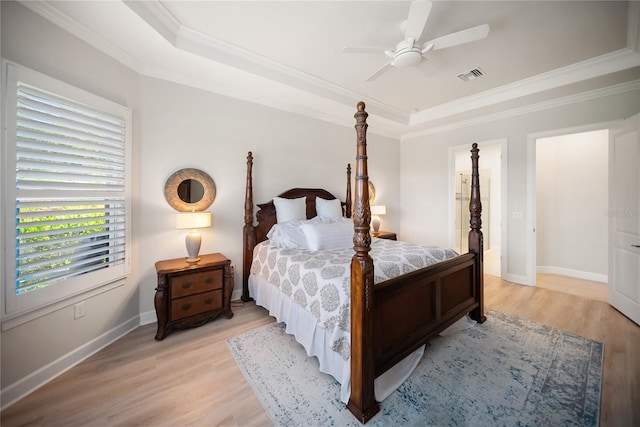 4735 Cassio Ct, Bradenton, FL 34211 - bedroom featuring a raised ceiling, crown molding, light wood finished floors, and a ceiling fan