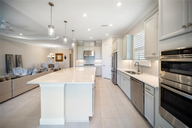 4735 Cassio Ct, Bradenton, FL 34211 - kitchen with stainless steel appliances, open floor plan, under cabinet range hood, decorative backsplash, and light tile patterned floors