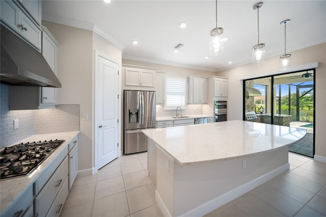 4735 Cassio Ct, Bradenton, FL 34211 - kitchen featuring stainless steel appliances, under cabinet range hood, crown molding, a kitchen island, and plenty of natural light